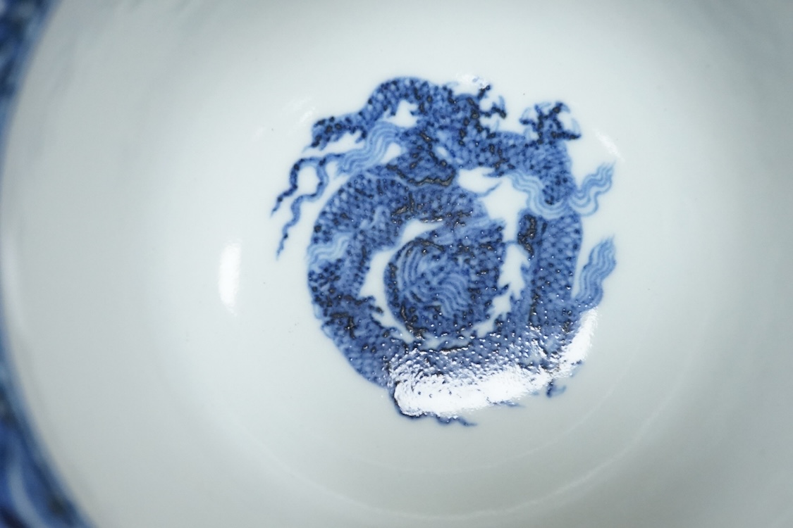 A Chinese blue and white stem bowl, painted with dragons in underglaze blue, 18cm high